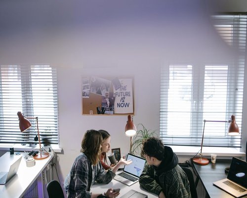 Editorial team collaborating in a modern workspace