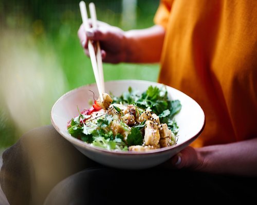 A balanced bowl of rice, fresh green vegetables, and protein typical of Malaysian cuisine